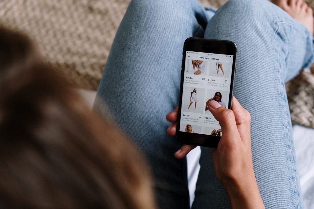 Girl browsing ecommerce store one phone