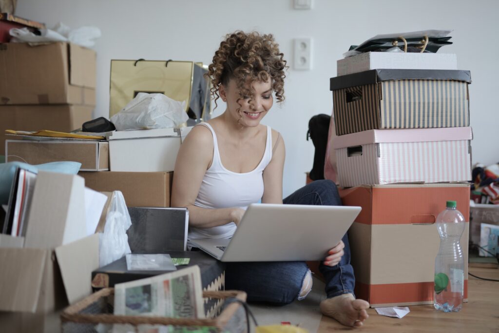 Woman online shopping on floor