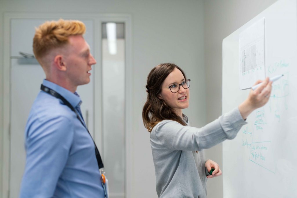 People looking at whiteboard