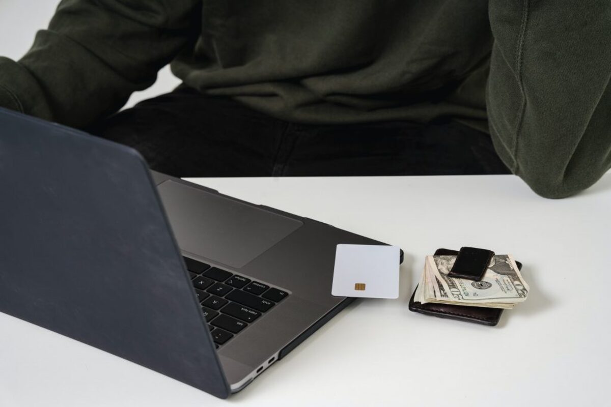 Laptop, credit card, wallet on table