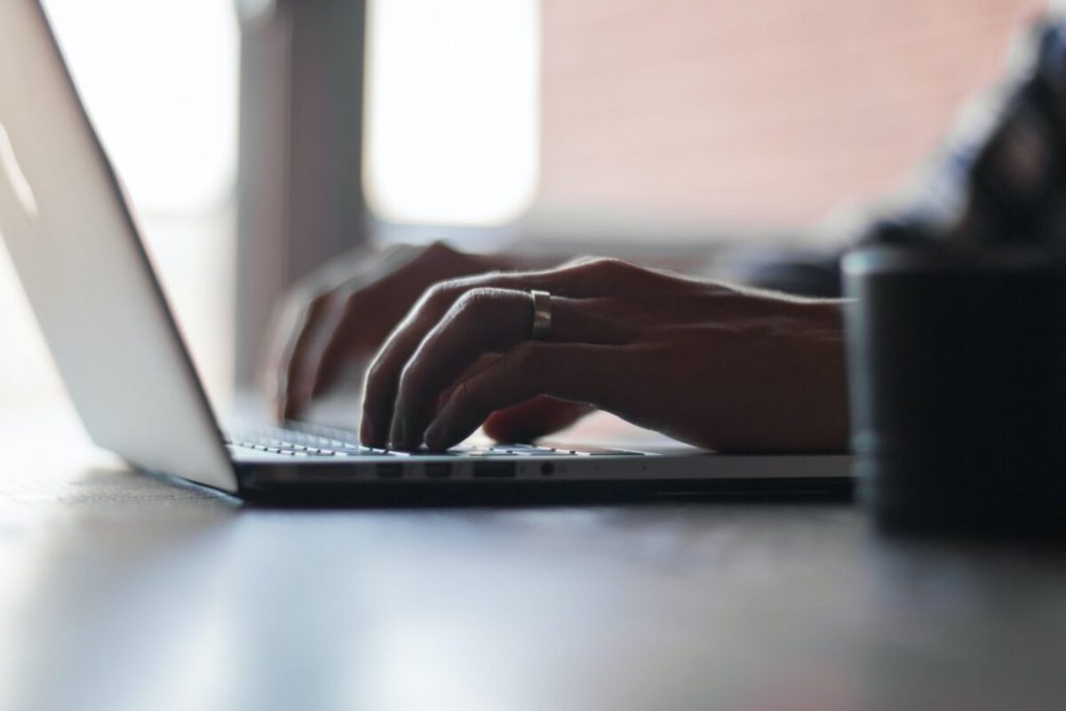 Woman typing on Macbook