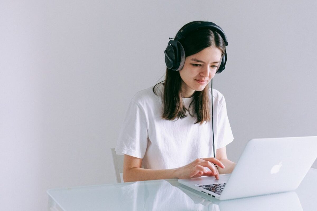 Woman with headphones using laptop