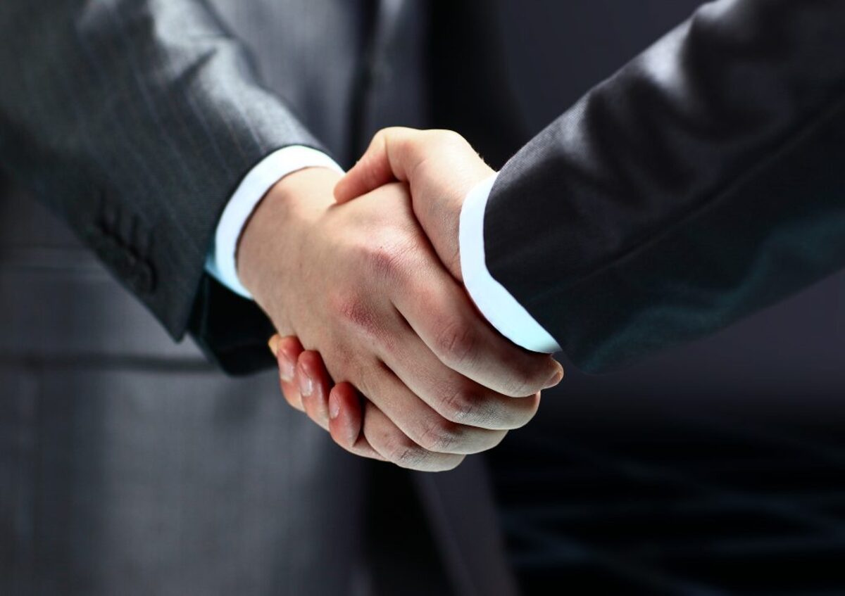 Two men in suits shaking hands