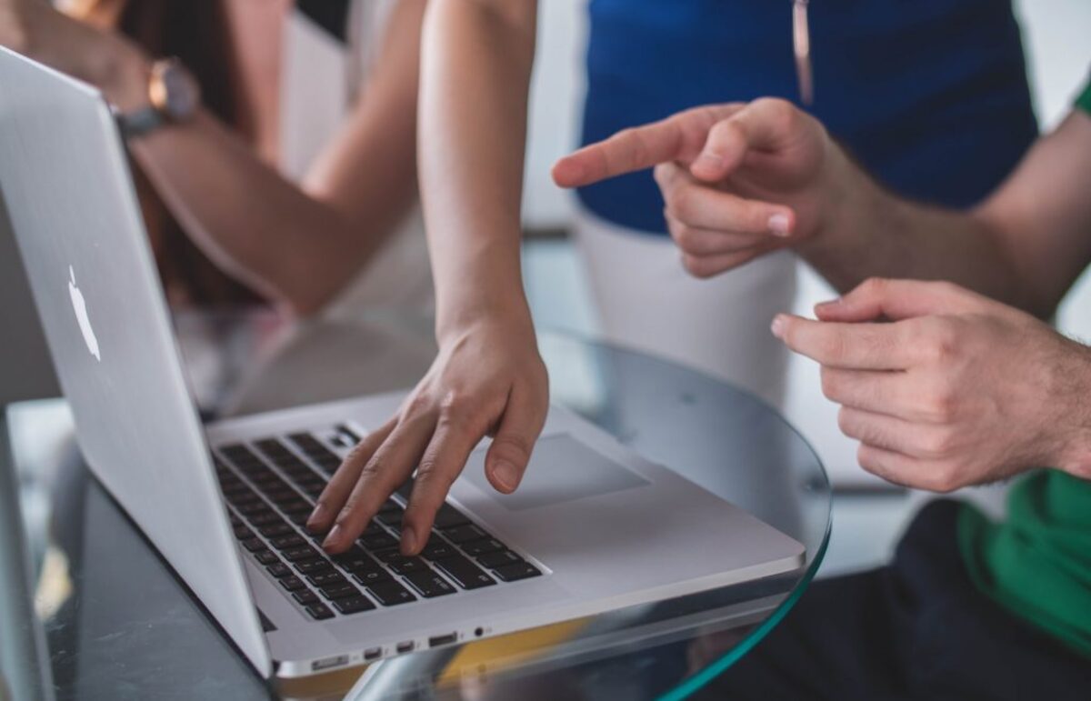 Man pointing at laptop screen