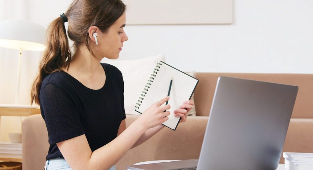 Focused woman using laptop while attending online webinar