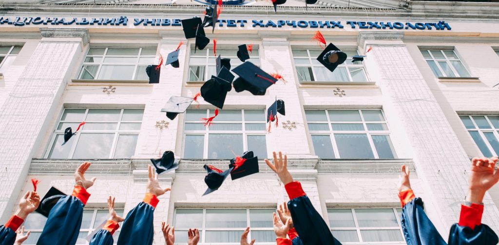 Graduates throwing caps 