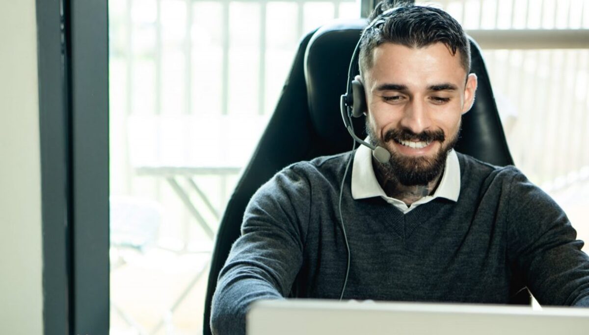 Man in black sweater wearing black headphones