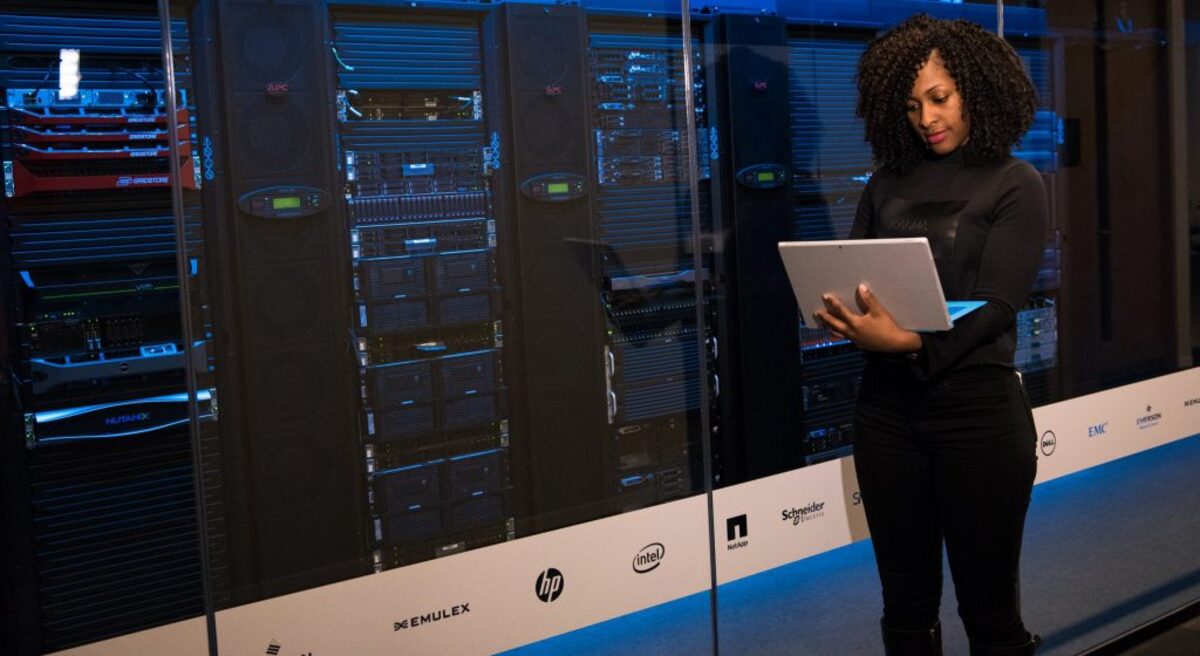 Woman standing while carrying laptop