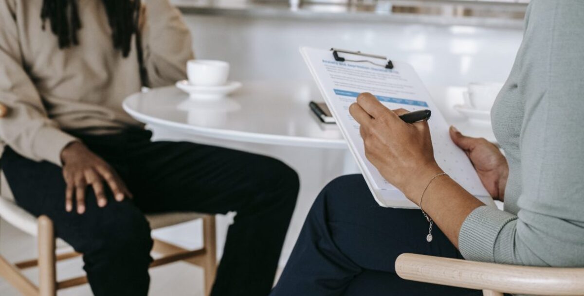 Crop faceless multiethnic interviewer and job seeker going through interview