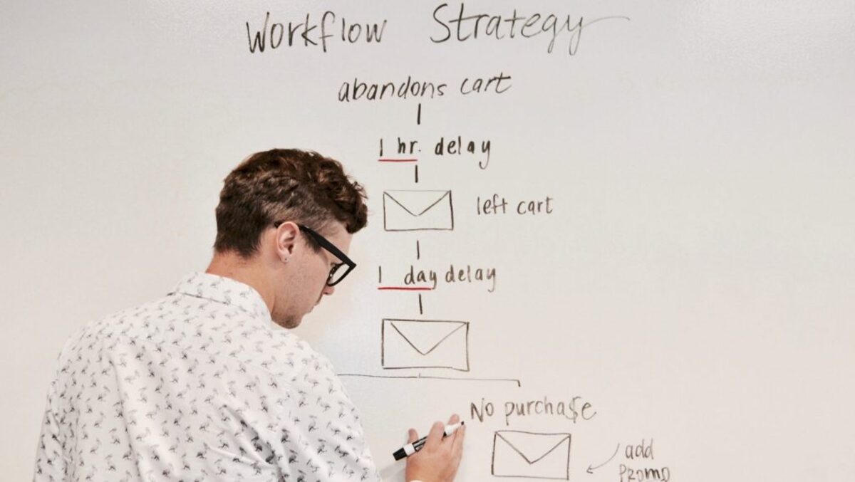 man writing on white board