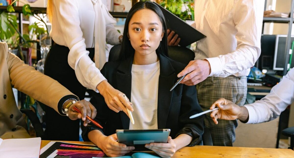 Woman using ipad brainstorming with her colleagues