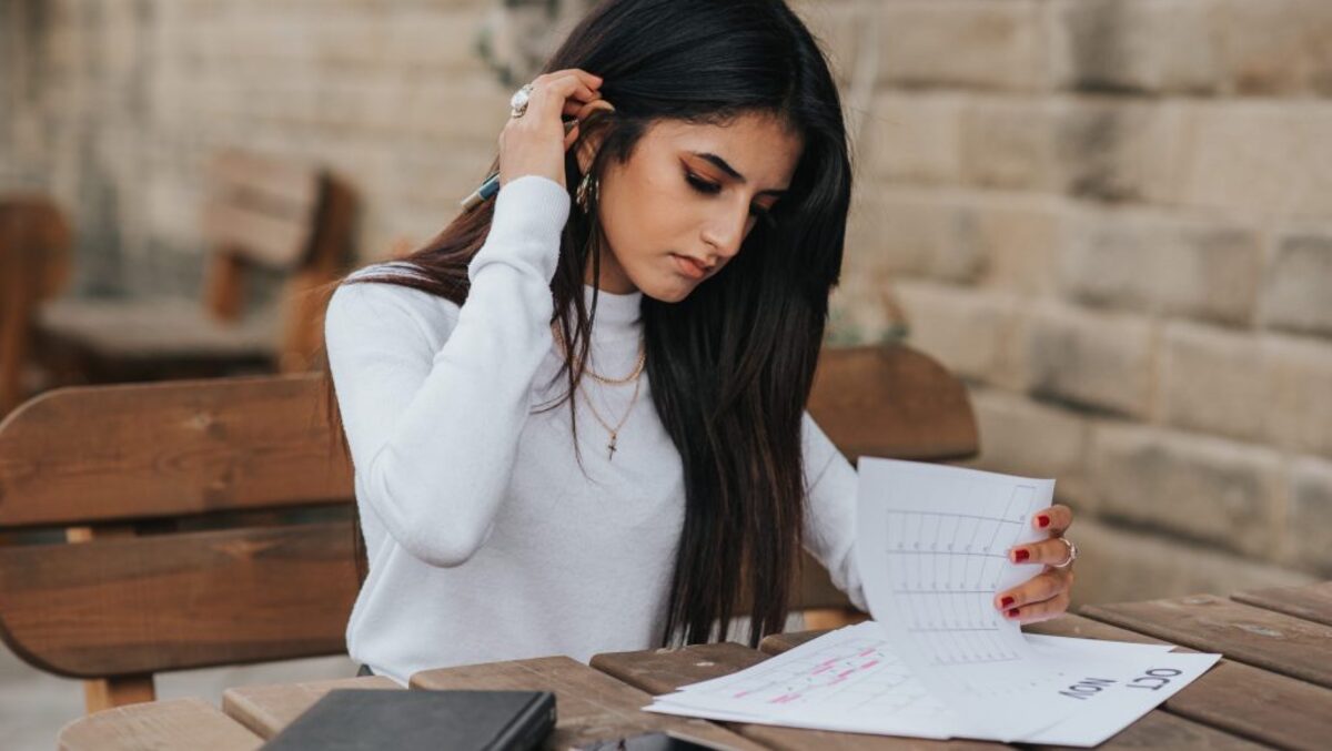 Ethnic young woman reading notes