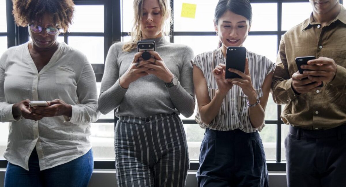 Group of diverse people using smartphones