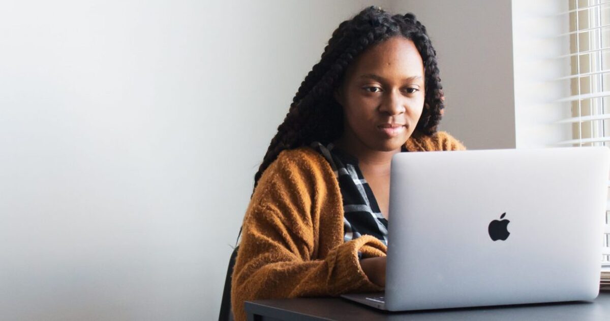 Woman typing on a Macbook