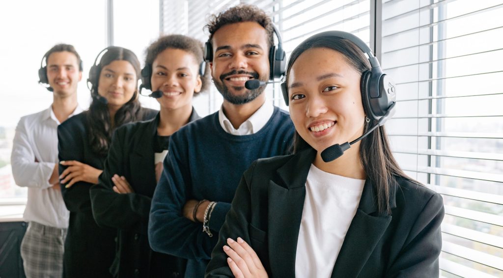 Happy call center agents looking at camera
