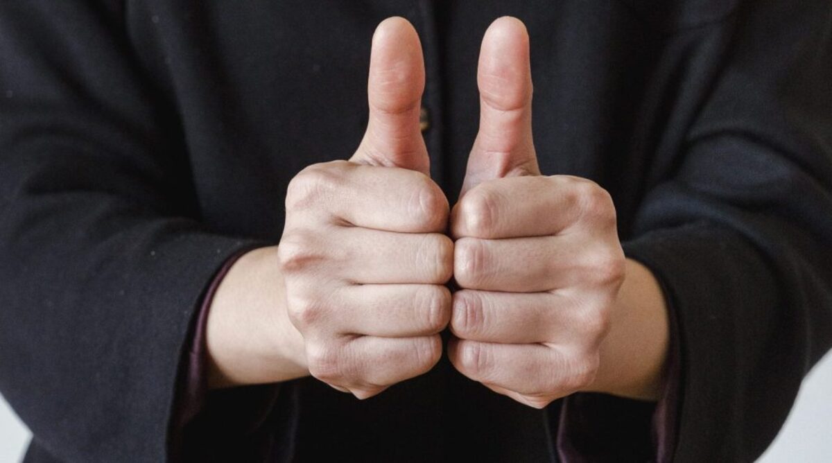 A person doing a two thumbs up