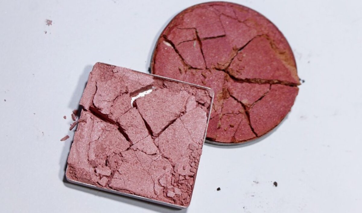 Two crushed makeup powders laying over one another.